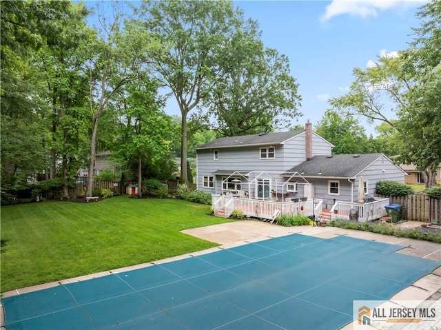 14 Devon Rd, Edison, NJ 08820 - back of house featuring a deck, a fenced backyard, a chimney, and a patio