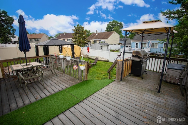 22 Woodcrest Dr, Old Bridge, NJ 08857 - wooden deck with a gazebo, outdoor dining area, a residential view, a fenced backyard, and area for grilling