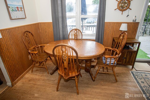 22 Woodcrest Dr, Old Bridge, NJ 08857 - dining area featuring light wood-style flooring, wainscoting, and wooden walls