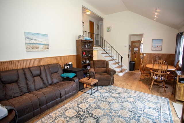 22 Woodcrest Dr, Old Bridge, NJ 08857 - living area featuring a wainscoted wall, wood finished floors, lofted ceiling, wood walls, and stairway