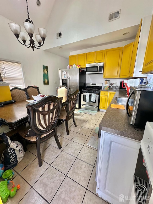 428 Broadhead Pl, Perth Amboy, NJ 08861 - kitchen featuring stainless steel appliances, high vaulted ceiling, a chandelier, dark countertops, and light tile patterned floors