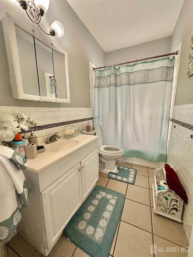 428 Broadhead Pl, Perth Amboy, NJ 08861 - full bathroom featuring tile walls, vanity, tile patterned floors, wainscoting, and shower / tub combo