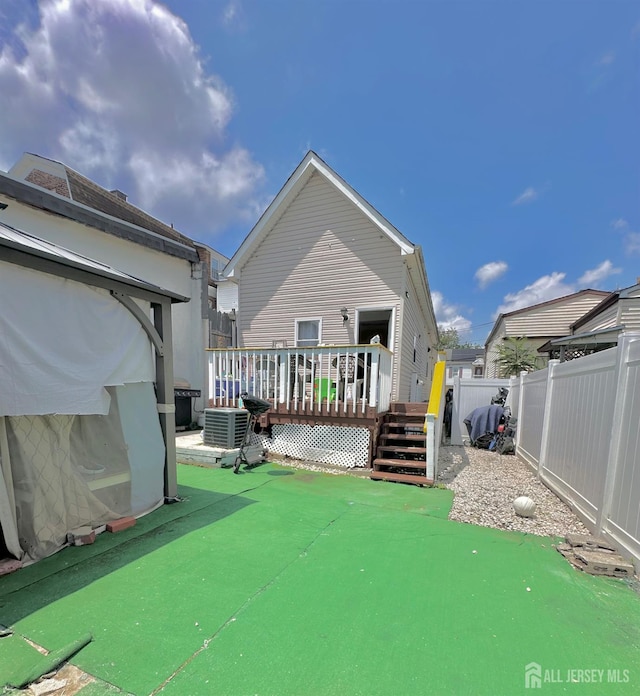 428 Broadhead Pl, Perth Amboy, NJ 08861 - rear view of property with a wooden deck and central AC unit