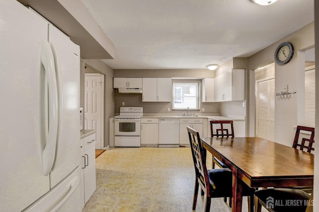 kitchen with sink, white cabinets, and white appliances