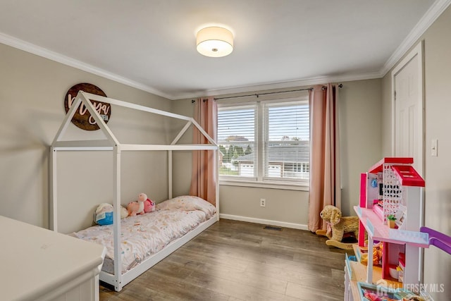 bedroom with dark wood-type flooring and crown molding