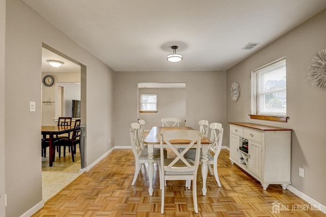 dining space with light parquet floors