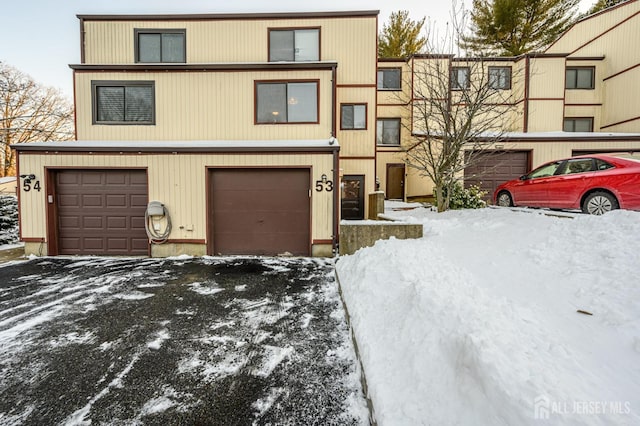 townhome / multi-family property with driveway and an attached garage