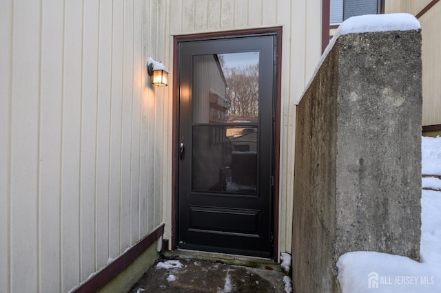 view of snow covered property entrance