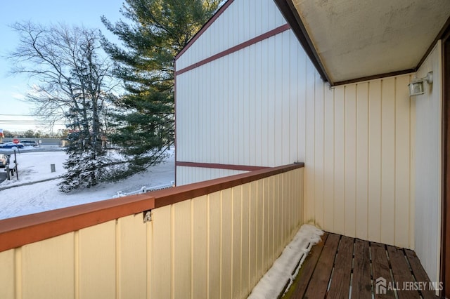 view of snow covered back of property