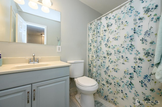 bathroom featuring toilet, a shower with curtain, vanity, and tile patterned floors