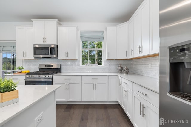 1617 Swales Ct, Monroe, NJ 08831 - kitchen with stainless steel appliances, dark wood-type flooring, white cabinets, light stone counters, and backsplash