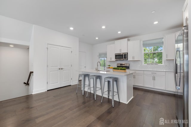 1617 Swales Ct, Monroe, NJ 08831 - kitchen featuring appliances with stainless steel finishes, dark wood-style flooring, white cabinetry, a sink, and recessed lighting