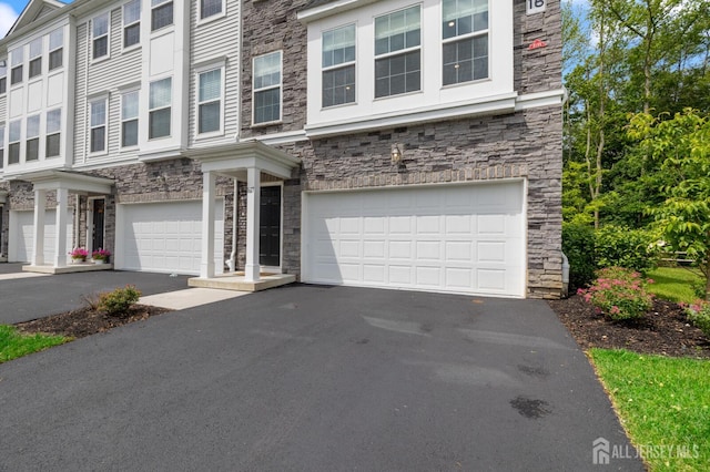 1617 Swales Ct, Monroe, NJ 08831 - townhome / multi-family property featuring stone siding, driveway, and a garage