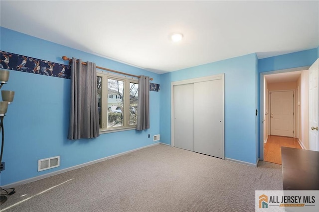 unfurnished bedroom featuring carpet flooring and a closet