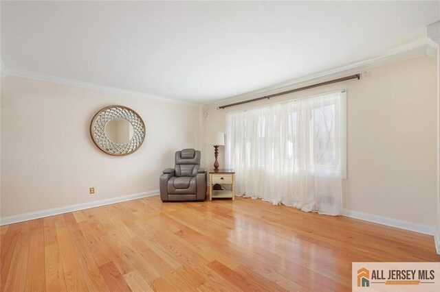 unfurnished room featuring light wood-type flooring and crown molding