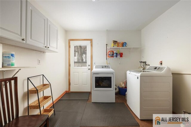 laundry room featuring separate washer and dryer and cabinets