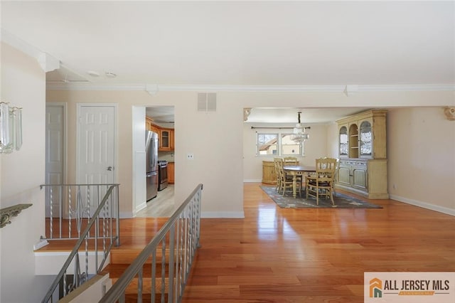 interior space featuring light hardwood / wood-style flooring and ornamental molding