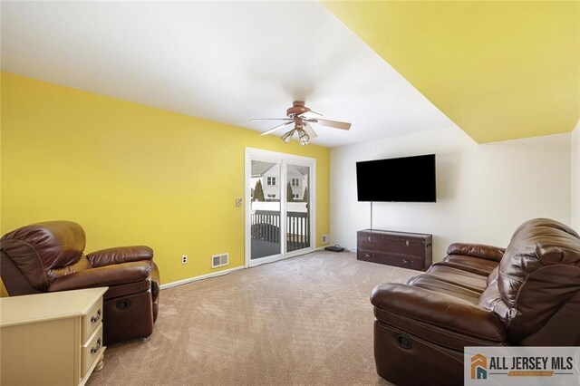 living room with light colored carpet and ceiling fan