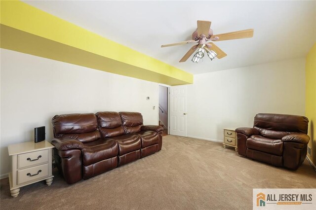 carpeted living room with ceiling fan