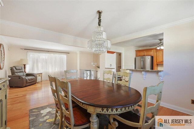 dining room featuring ceiling fan with notable chandelier, ornamental molding, and light hardwood / wood-style floors