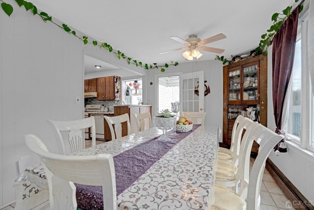 dining space with ceiling fan and light tile patterned floors