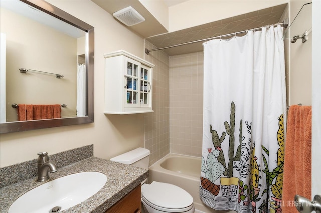 full bathroom with vanity, shower / tub combo, and toilet