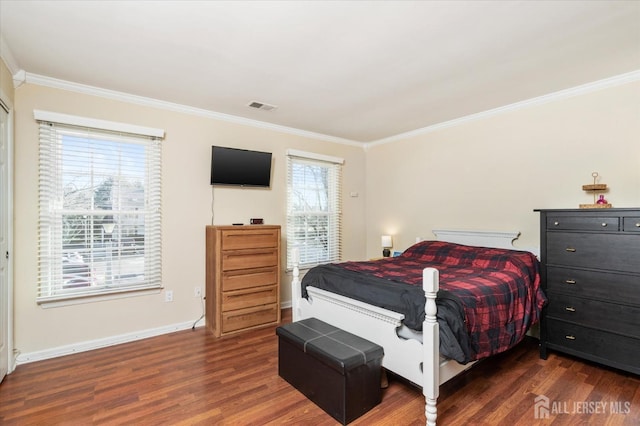 bedroom with crown molding and dark hardwood / wood-style floors