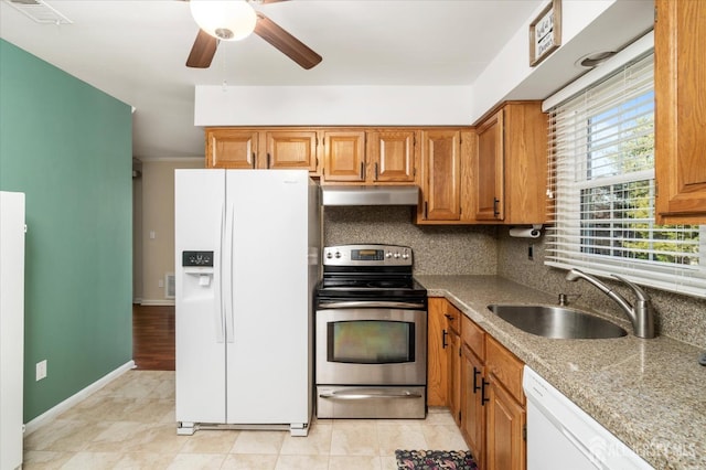 kitchen featuring tasteful backsplash, sink, ceiling fan, light stone counters, and white appliances