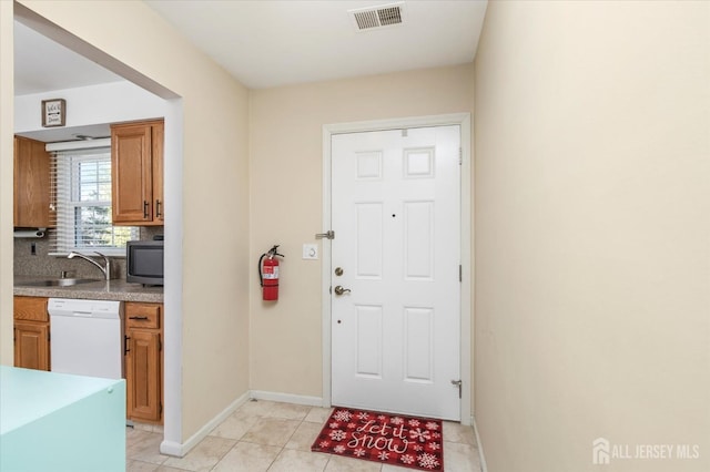 tiled entrance foyer featuring sink