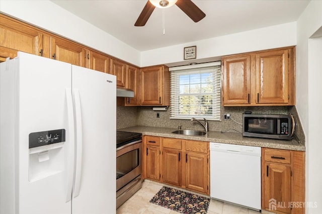 kitchen with light tile patterned flooring, sink, ceiling fan, stainless steel appliances, and backsplash