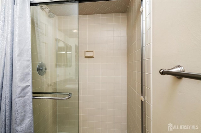 bathroom featuring a shower with shower door