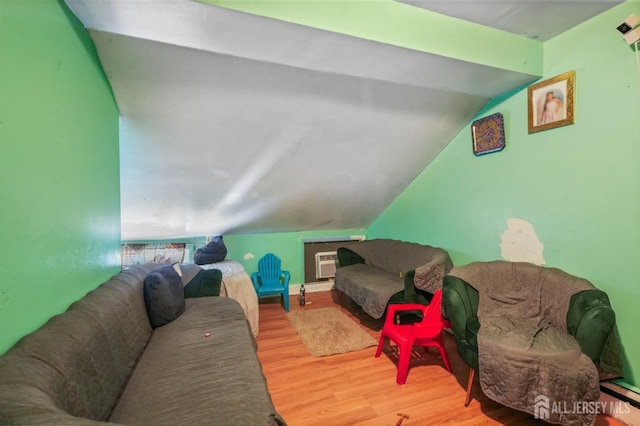 184 Seaman St, New Brunswick, NJ 08901 - living room featuring wood finished floors, lofted ceiling, and an AC wall unit