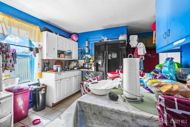 184 Seaman St, New Brunswick, NJ 08901 - kitchen featuring black refrigerator with ice dispenser, white cabinets, light tile patterned flooring, light countertops, and open shelves