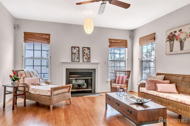 57 Cortland Dr N, East Brunswick, NJ 08816 - living area featuring a ceiling fan, baseboards, a glass covered fireplace, and light wood-type flooring