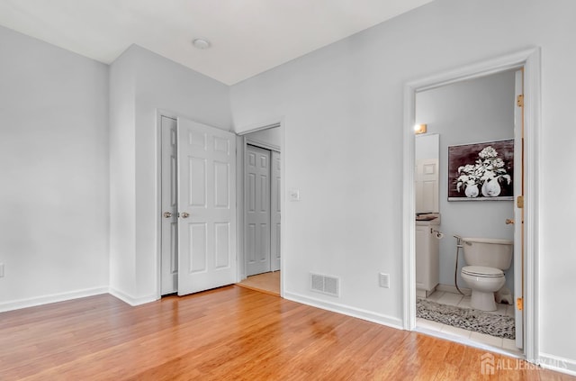 57 Cortland Dr N, East Brunswick, NJ 08816 - unfurnished bedroom with baseboards, ensuite bathroom, light wood-style floors, and visible vents