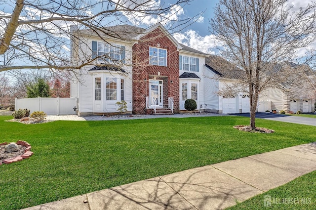 57 Cortland Dr N, East Brunswick, NJ 08816 - view of front of home with a front yard, driveway, fence, and a garage