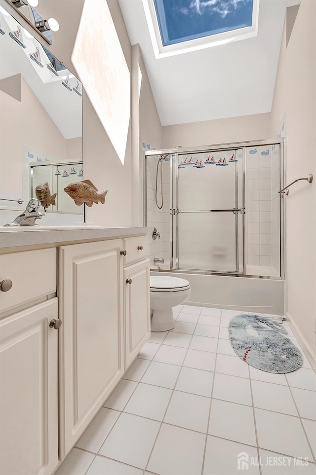57 Cortland Dr N, East Brunswick, NJ 08816 - bathroom with toilet, shower / bath combination with glass door, vaulted ceiling with skylight, tile patterned floors, and vanity