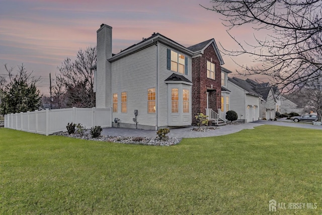 57 Cortland Dr N, East Brunswick, NJ 08816 - exterior space with a yard, fence, a chimney, and driveway