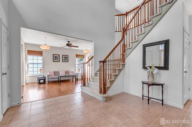 57 Cortland Dr N, East Brunswick, NJ 08816 - staircase with tile patterned flooring, a high ceiling, baseboards, and ceiling fan