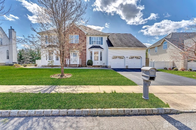 57 Cortland Dr N, East Brunswick, NJ 08816 - colonial inspired home with a front yard, a garage, and driveway