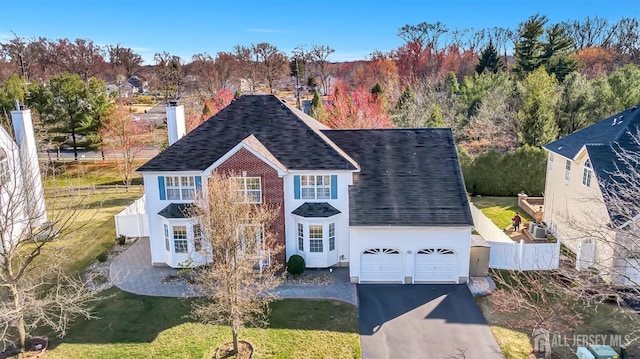 57 Cortland Dr N, East Brunswick, NJ 08816 - view of front of property with a shingled roof, driveway, fence, and a front lawn