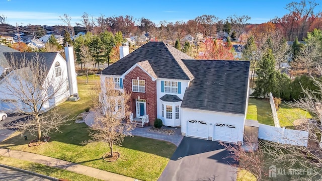 57 Cortland Dr N, East Brunswick, NJ 08816 - traditional home featuring a garage, a chimney, a front lawn, driveway, and roof with shingles