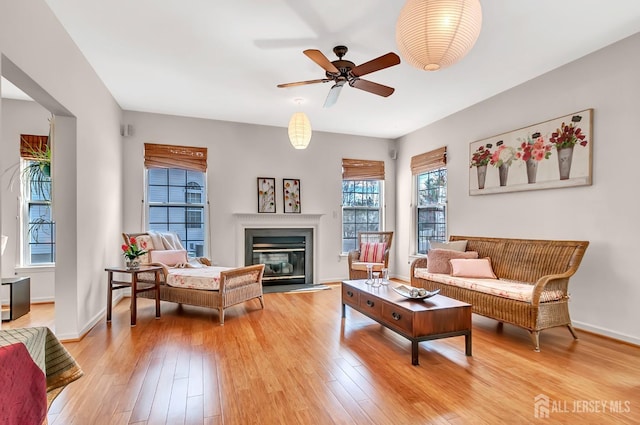 57 Cortland Dr N, East Brunswick, NJ 08816 - living area featuring light wood-style floors, baseboards, ceiling fan, and a glass covered fireplace