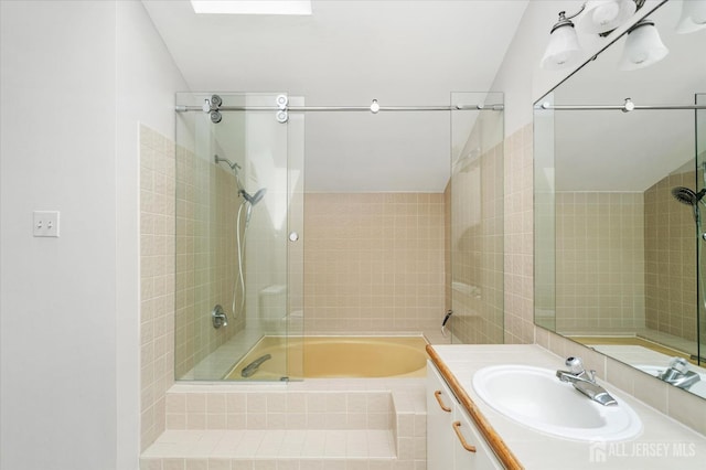 bathroom featuring vanity and tiled shower / bath combo