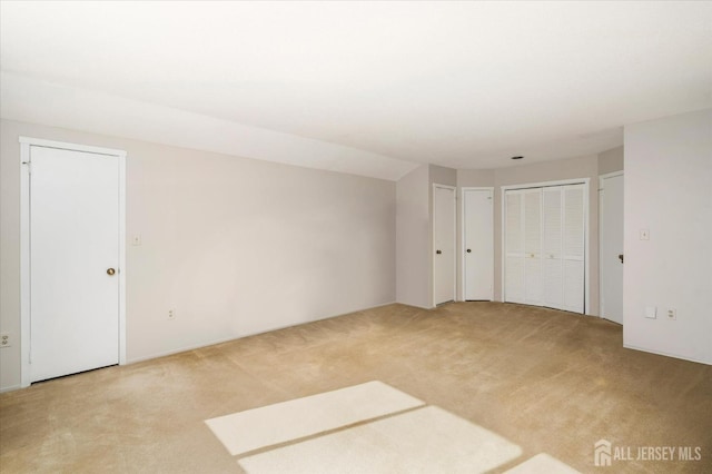 unfurnished room with light carpet