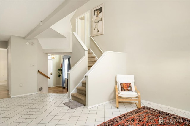 staircase featuring tile patterned floors