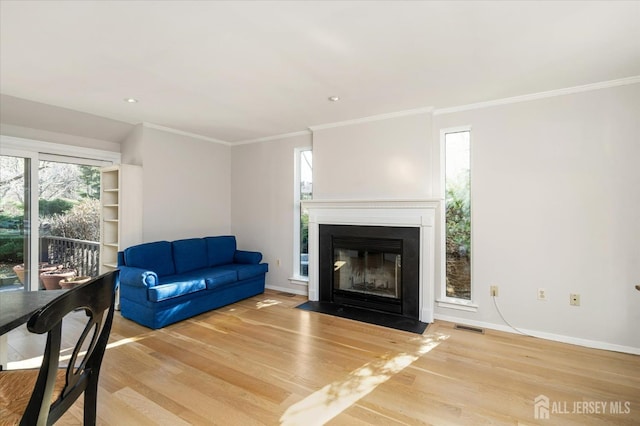 living room featuring crown molding and hardwood / wood-style floors