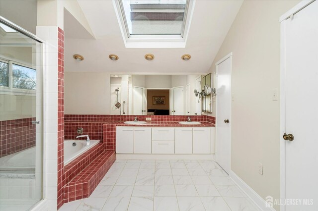 bathroom featuring independent shower and bath, vaulted ceiling, and vanity