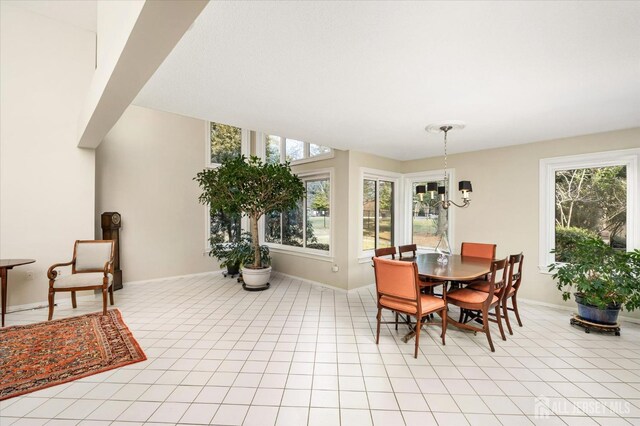 dining space featuring an inviting chandelier and light tile patterned flooring