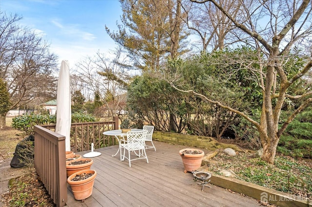 wooden terrace featuring outdoor dining area